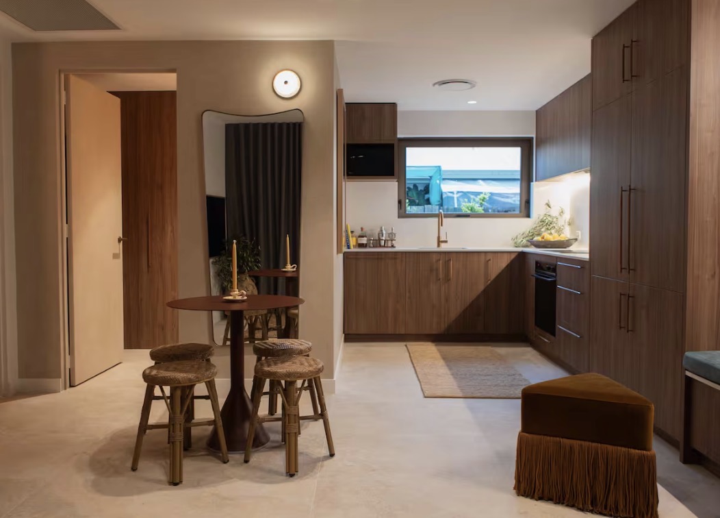 Warm timber kitchen and dining nook inside a Belmont Noosa apartment