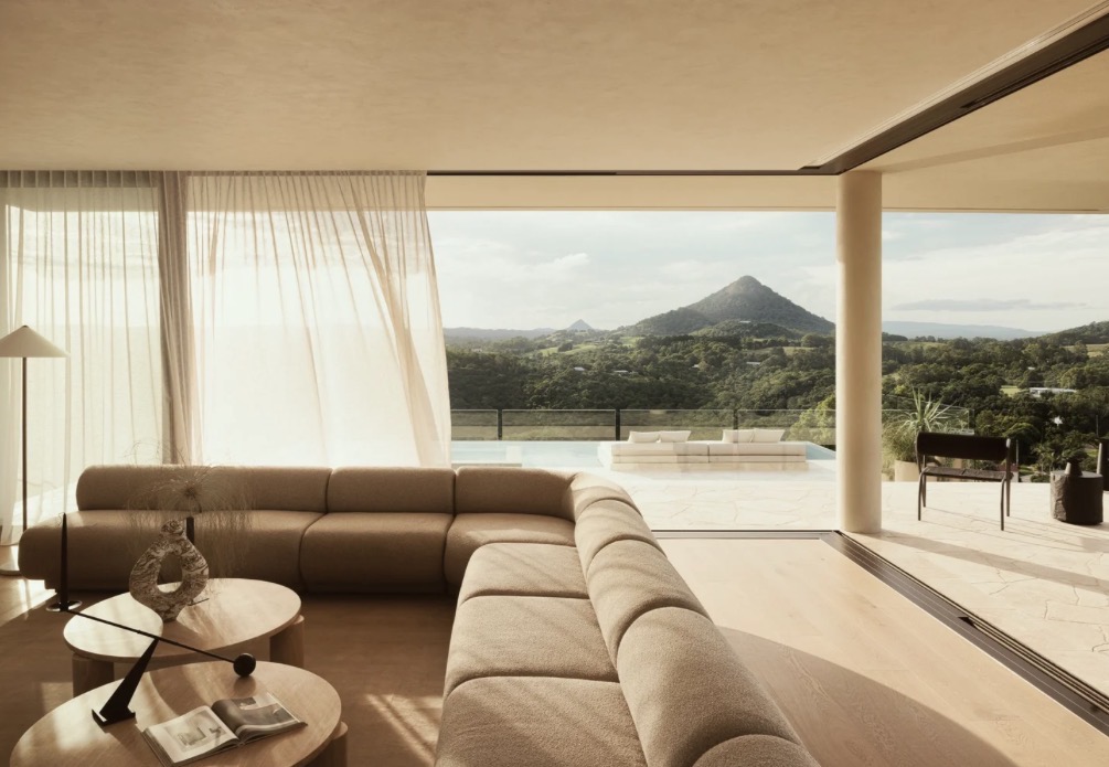 Open-plan Noosa living room looking out to the hinterland at sunset