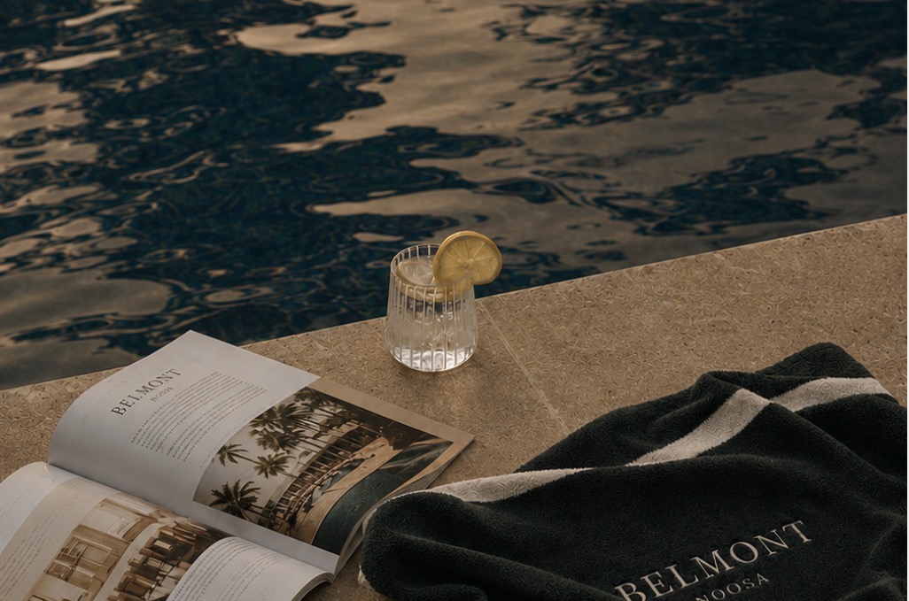 Belmont Noosa towel and chilled drink beside a dark pool at golden hour